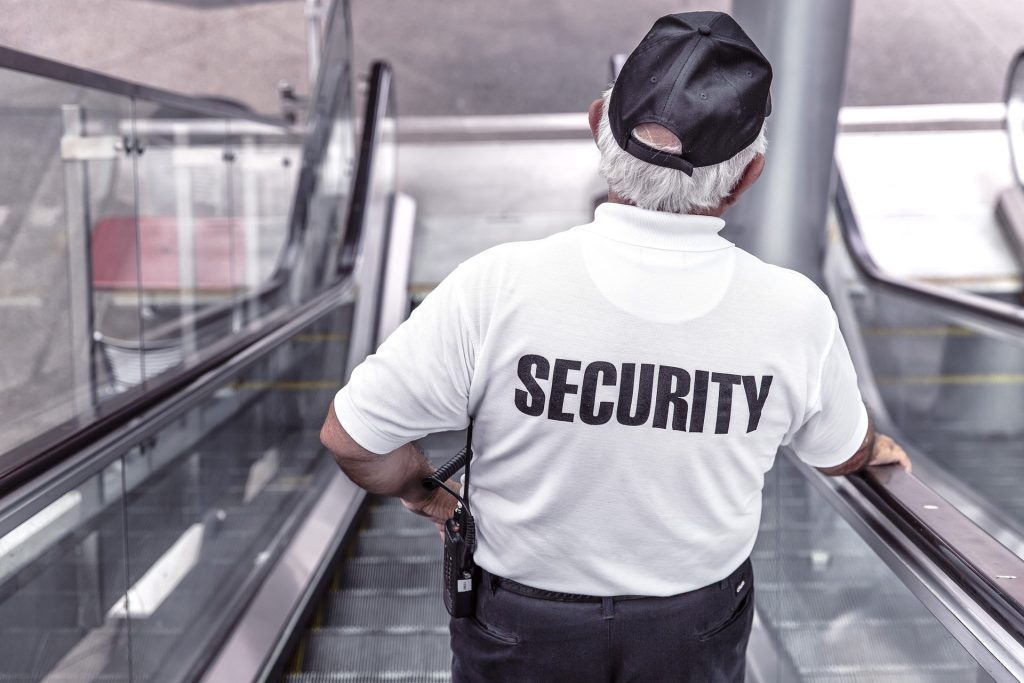 Safety in Italy - Security guard on escalator