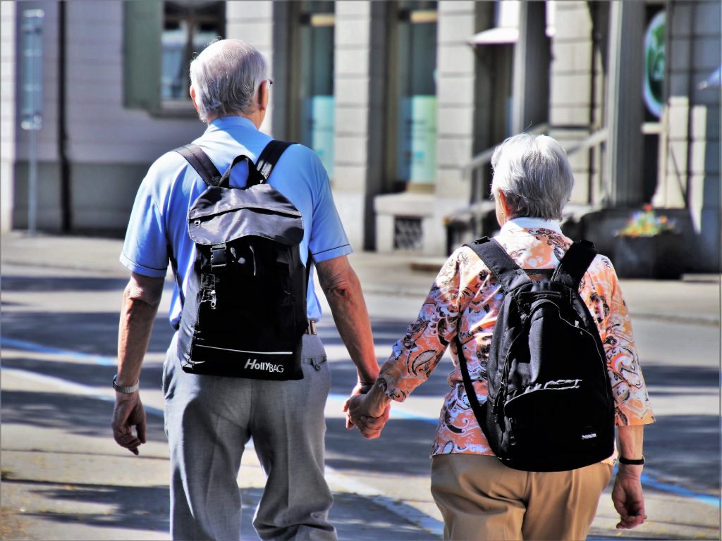 Senior couple holding hands - Senior Discounts in Italy